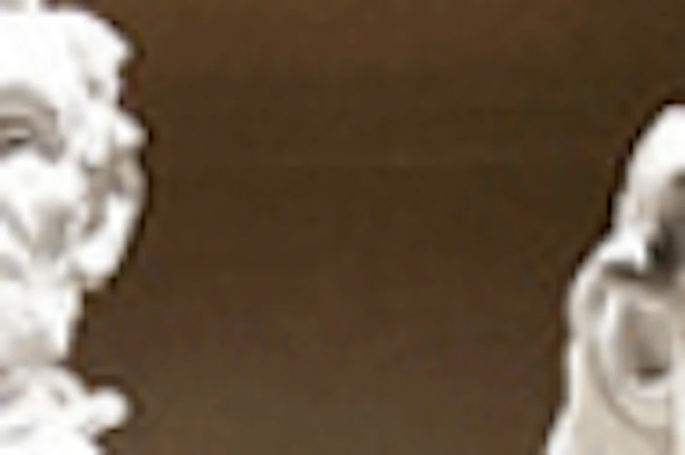 Statue of Abraham Lincoln seated in the Lincoln Memorial with an inscription above.