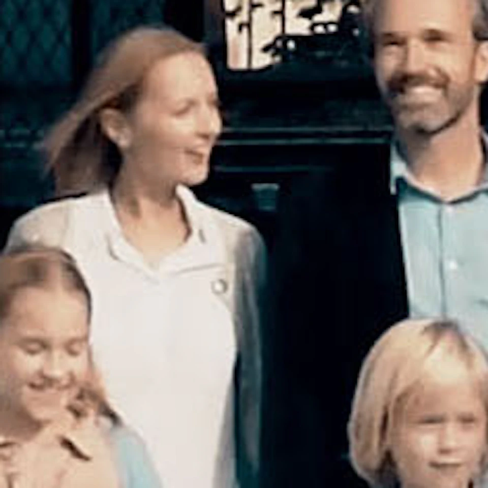 Family of four stands at the entrance of Historium Brugge, a historic building with decorative stone arches and signage.