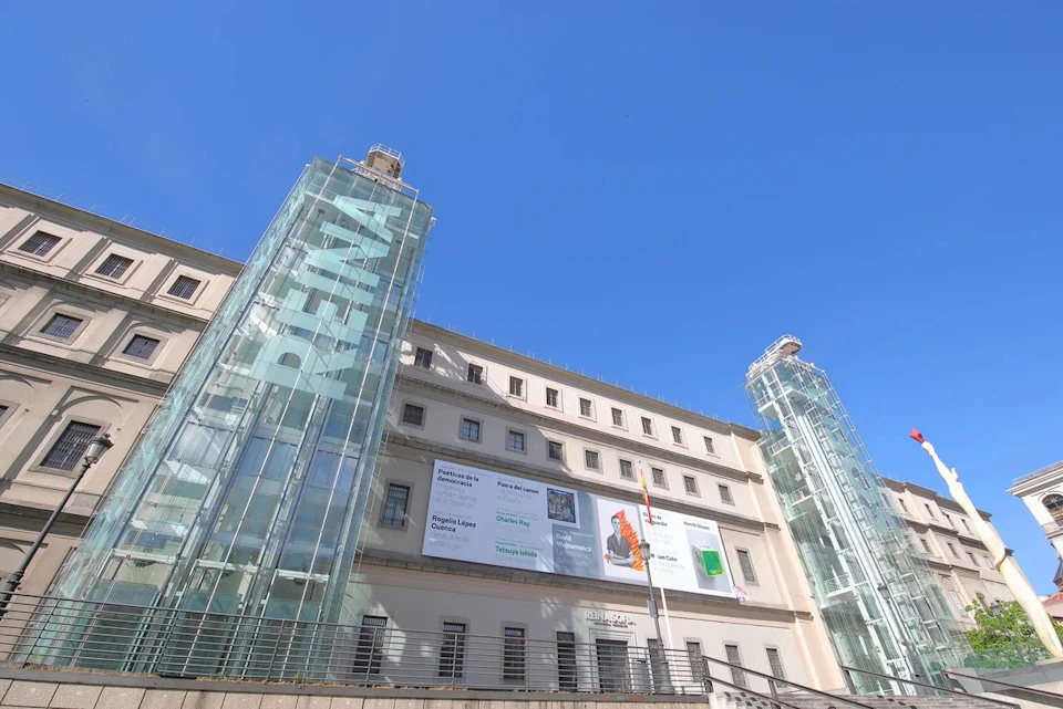 Glass elevators of the Reina Sofía Museum, a modern structure attached to the historical facade of the building.