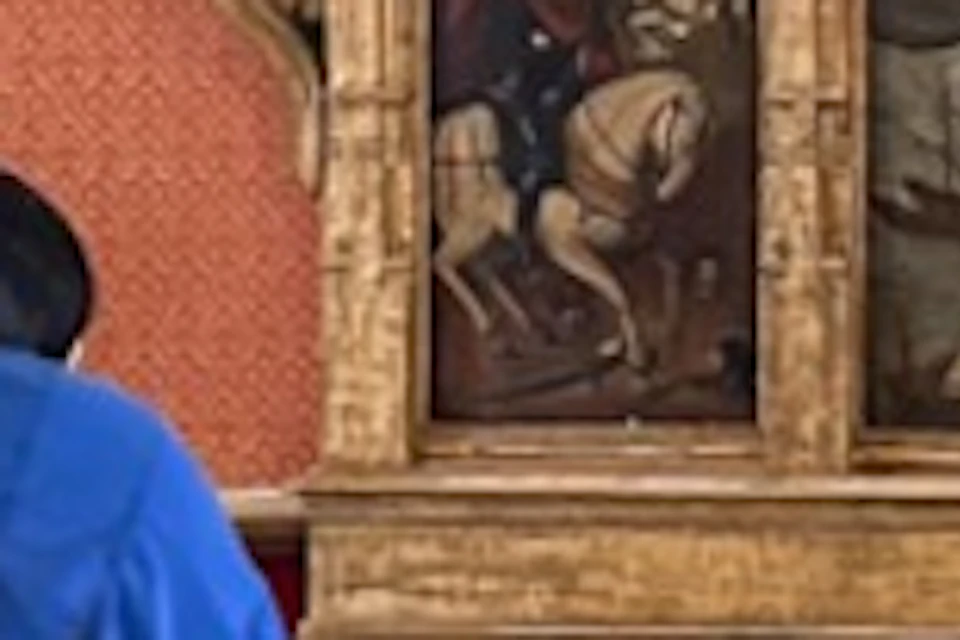 People observing a large religious painting in a historic room with ornate walls and decorative elements.