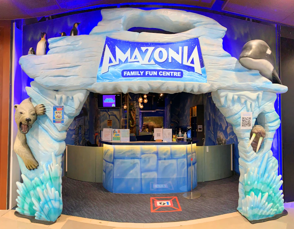 Entrance to the Amazonia Family Fun Centre featuring ice-themed decor and a reception desk.