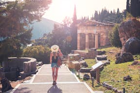 A guest walking towards the temple of Apollo at Delphi archaelogical site