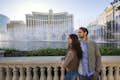 couple overlooking the bellagio hotel and fountain in vegas