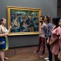 Guida e gruppo davanti al dipinto Le Moulin de la Galette di Renoir