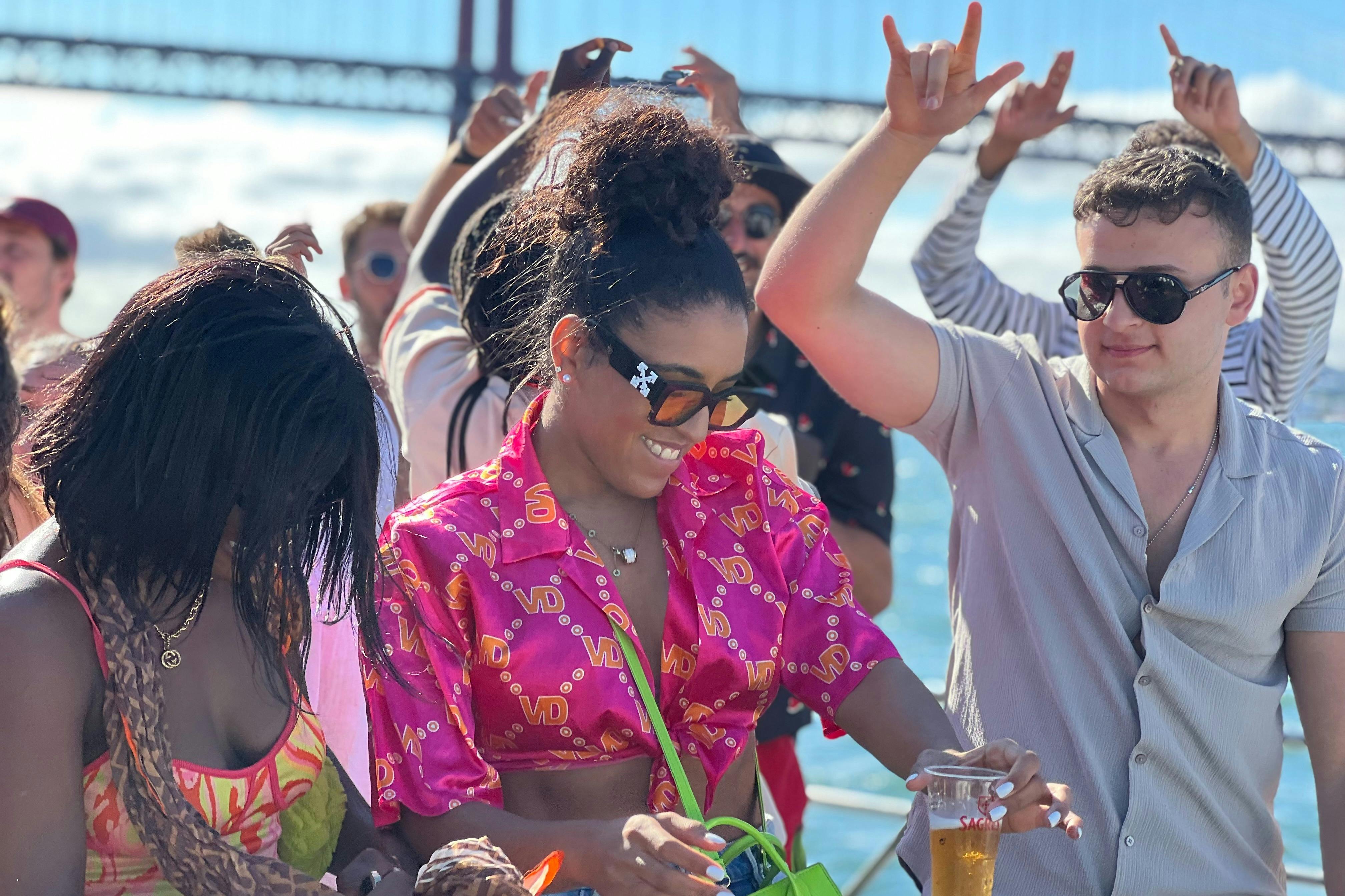 Young people dancing on a boat party in Lisbon