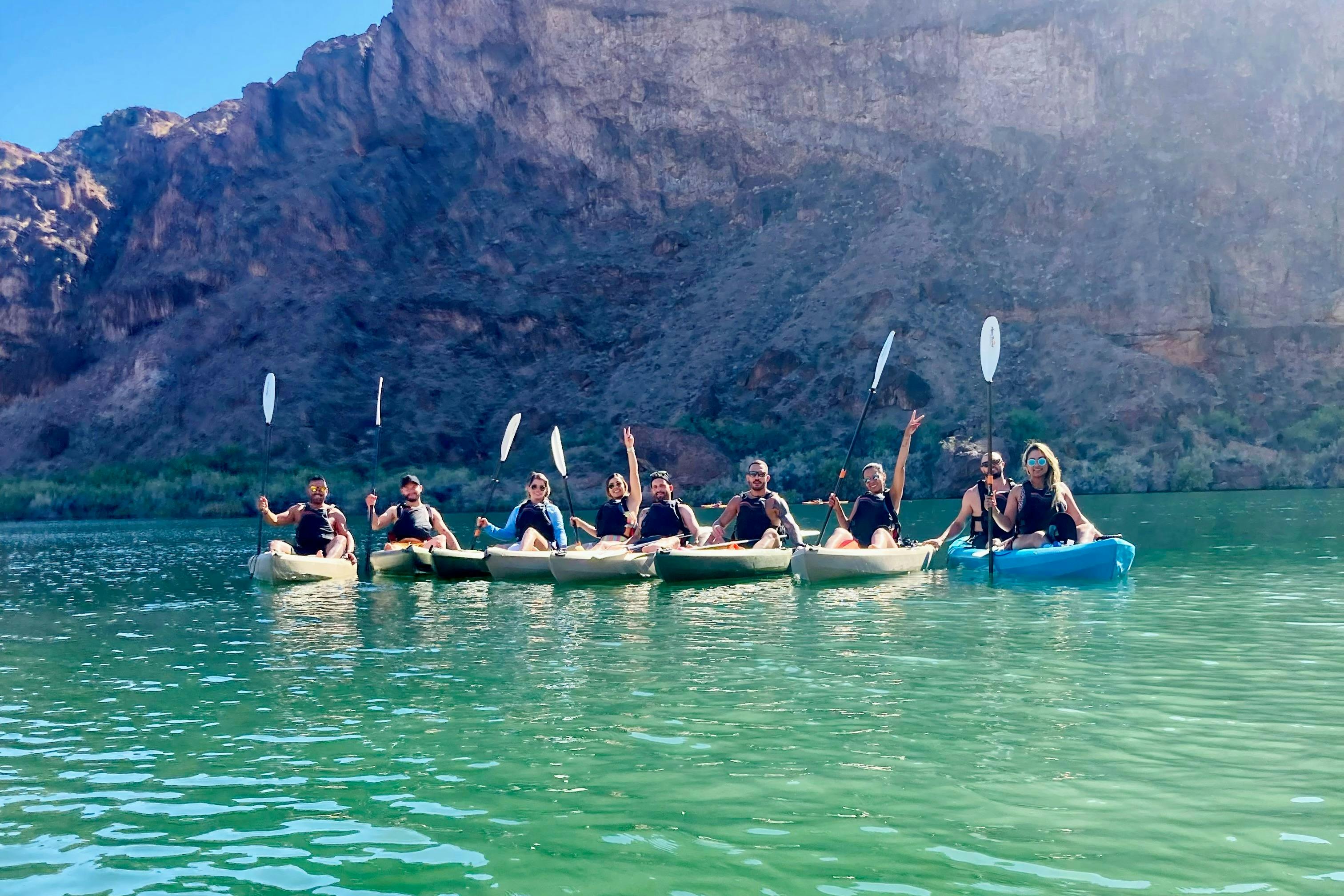 A group of kayakers smile for the camera.