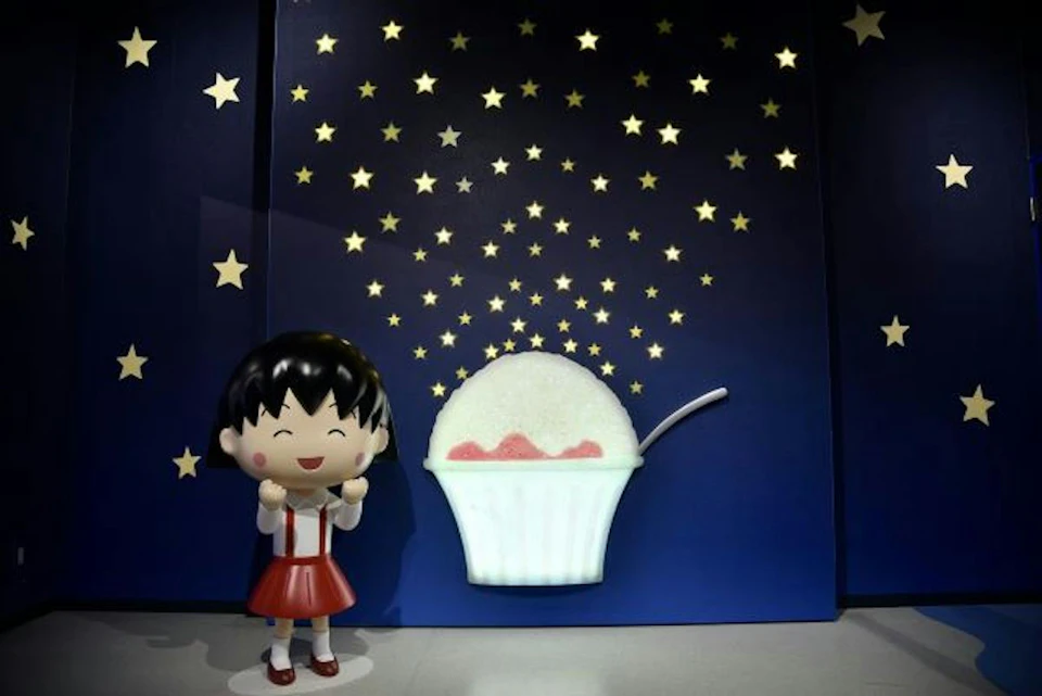 A cartoon-like figure of a smiling girl in a red dress stands next to a glowing dessert against a starry backdrop.