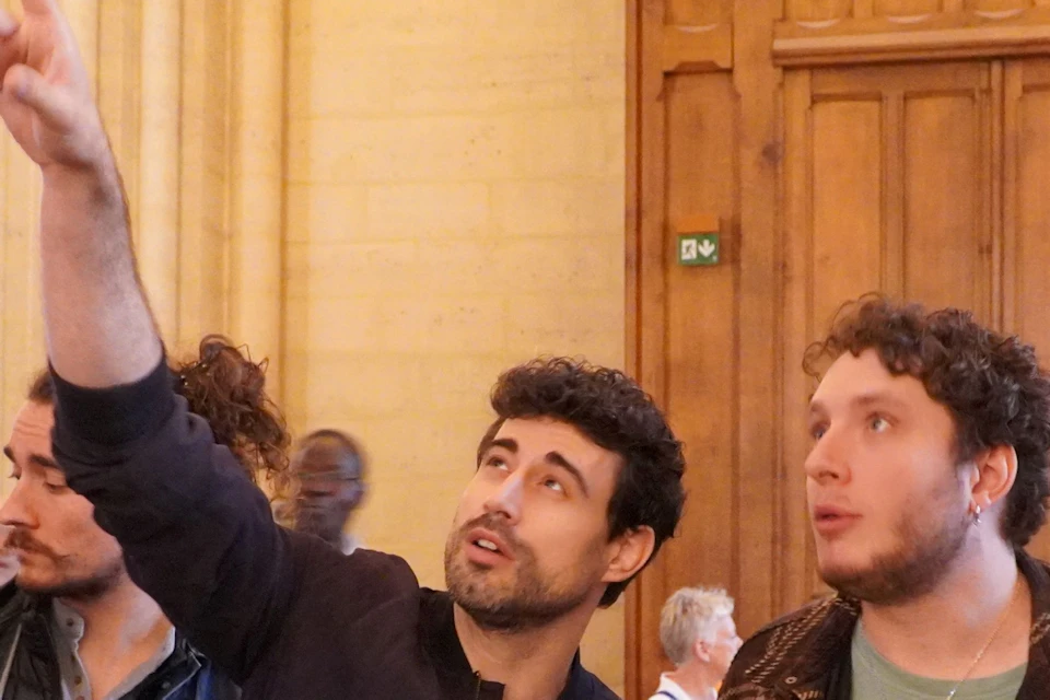 The supplier guides and points out details inside Notre Dame Cathedral.