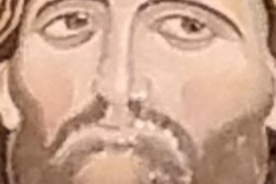 A mosaic depicts Jesus with a halo, raised right hand, and a book in his left hand, against a golden dome background.