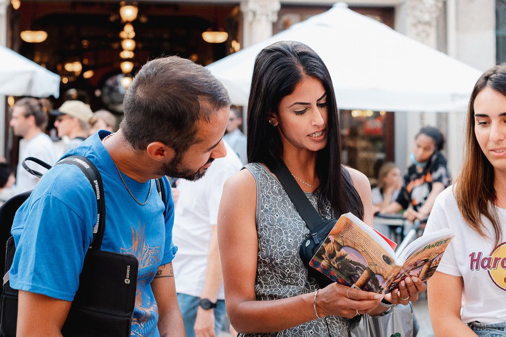 A woman is reading a Harry Potter book being heard by a guide