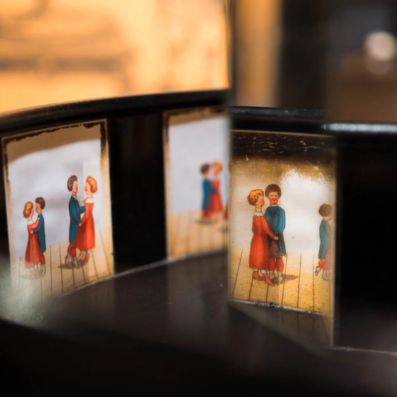 Vintage animation device with images of a couple dancing. The images are displayed in a circular sequence.