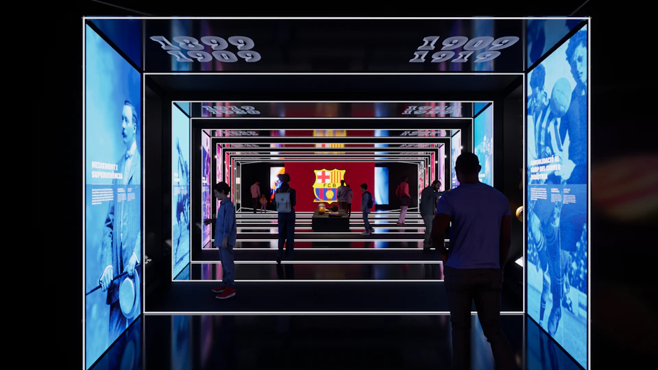People walking through an illuminated tunnel with mirrored walls displaying a large FC Barcelona emblem in the background.