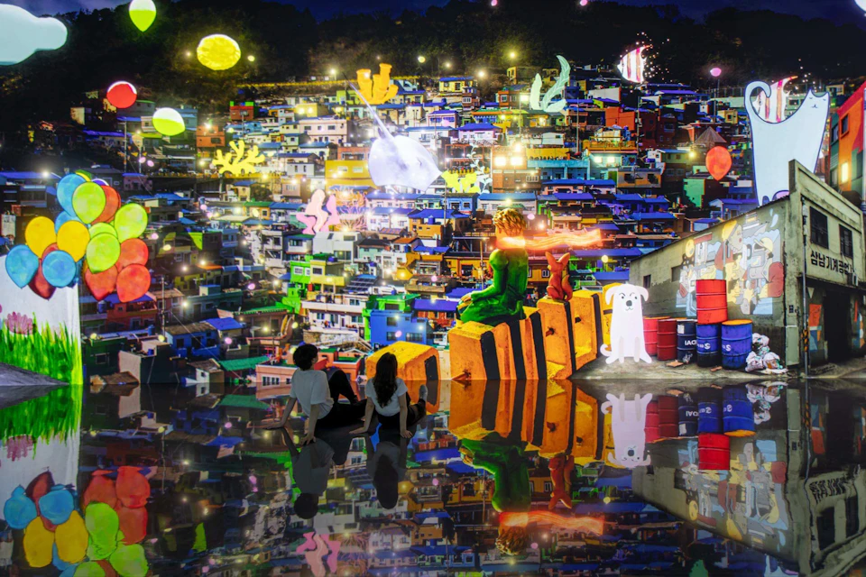 Three people sit on a reflective floor, facing a colorful, illuminated mural of a vibrant cityscape with artistic elements.