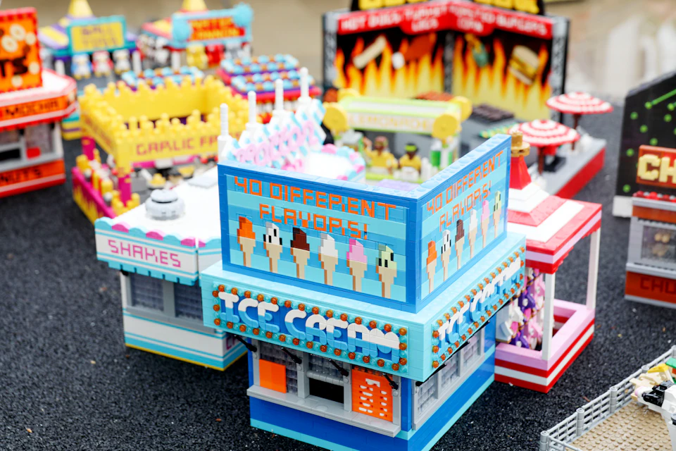 LEGO ice cream shop with a sign that reads "40 Different Flavors," surrounded by other colorful LEGO food stands.