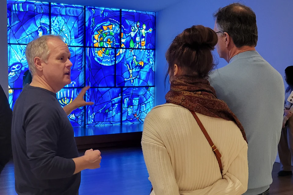 Guide showing Chagall's America Windows