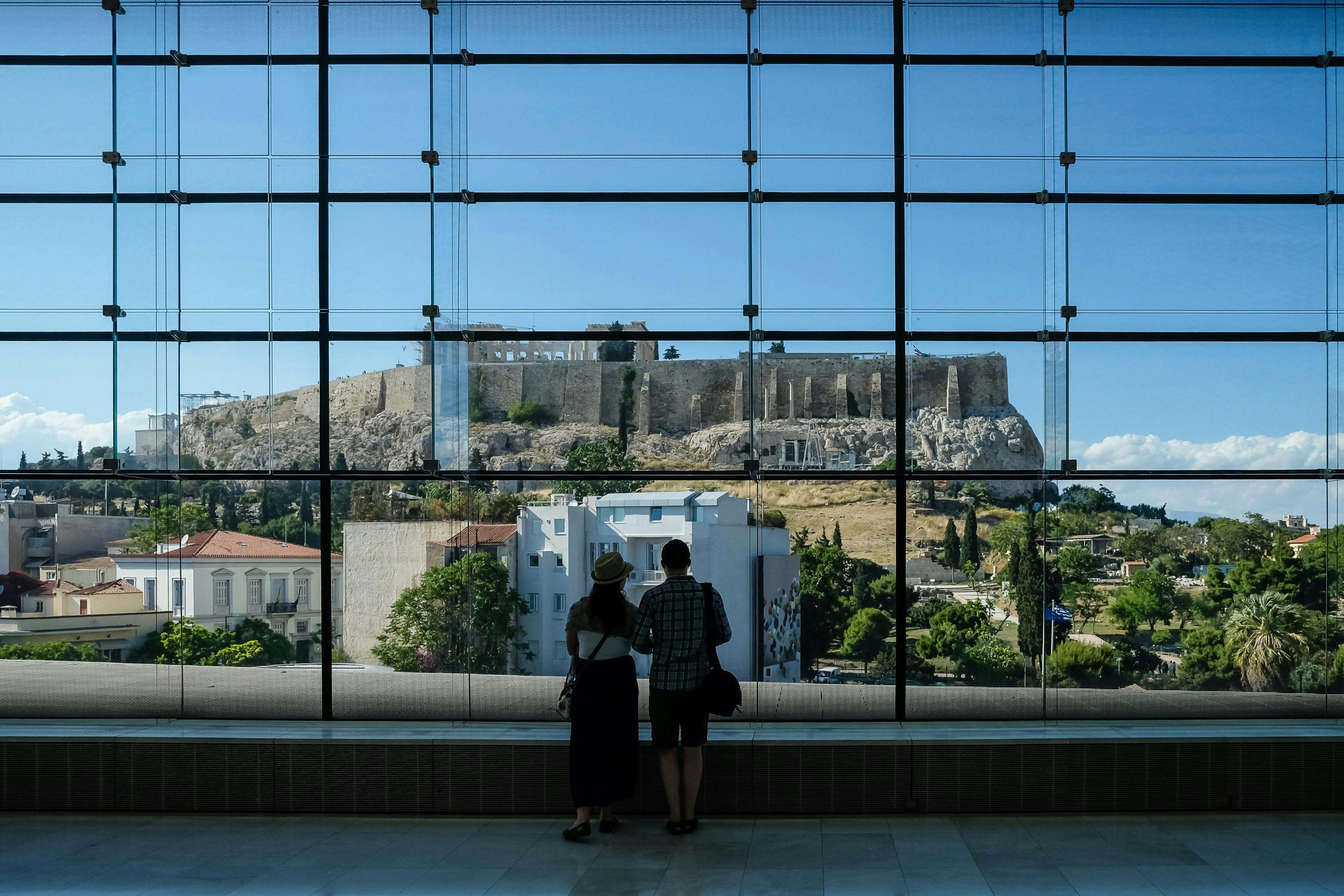 Guests watching the Acropolis from the Acropolis Museum