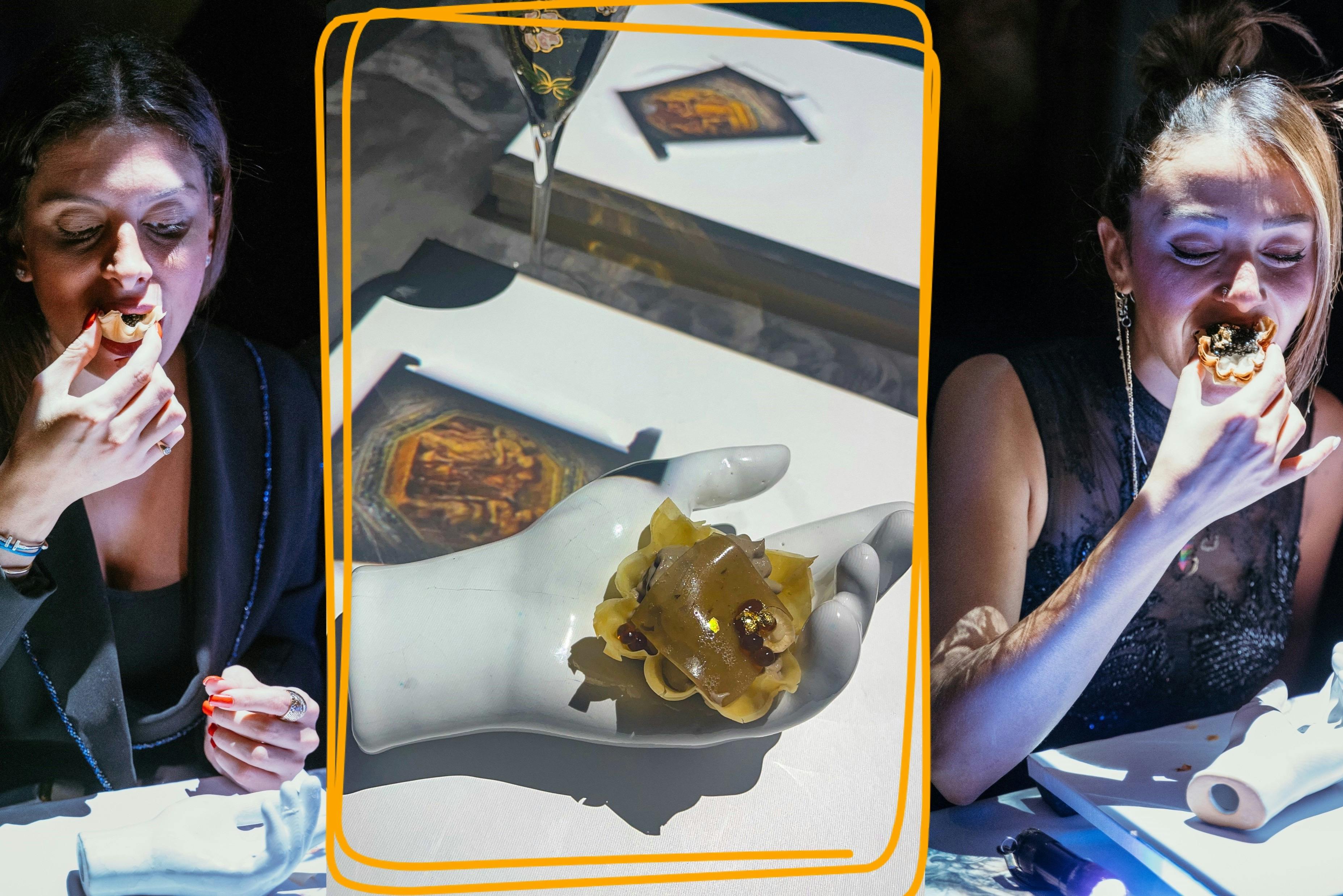 Οι επισκέπτες που απολαμβάνουν το πρώτο πιάτο Michelangelo στην καθηλωτική τραπεζαρία Seven Paintings