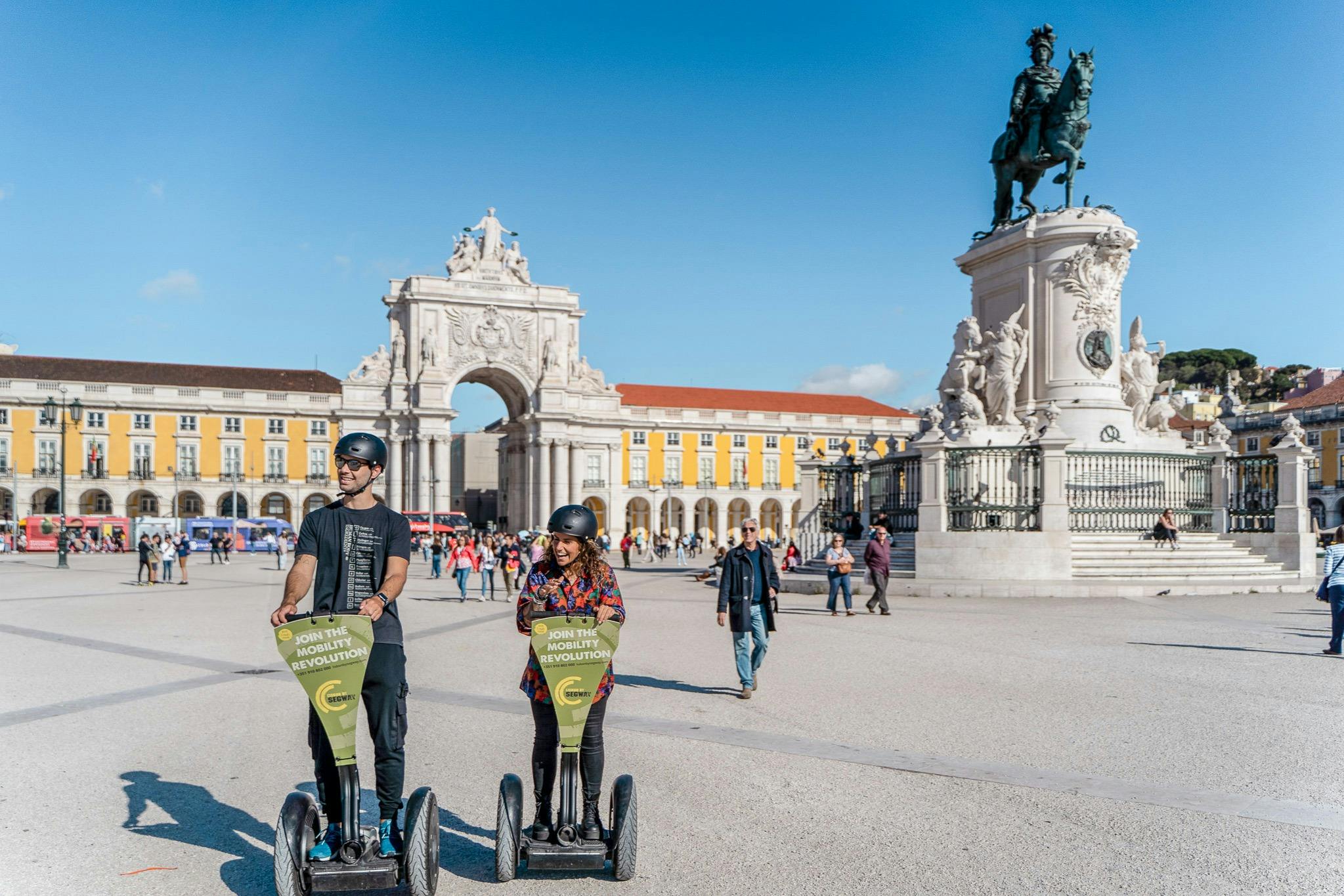 Tourists exploring Lisbon with a Segway guide tour. On Commerce Square.