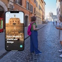 A woman with a pink backpack stands on a cobblestone street in front of a smartphone display showing