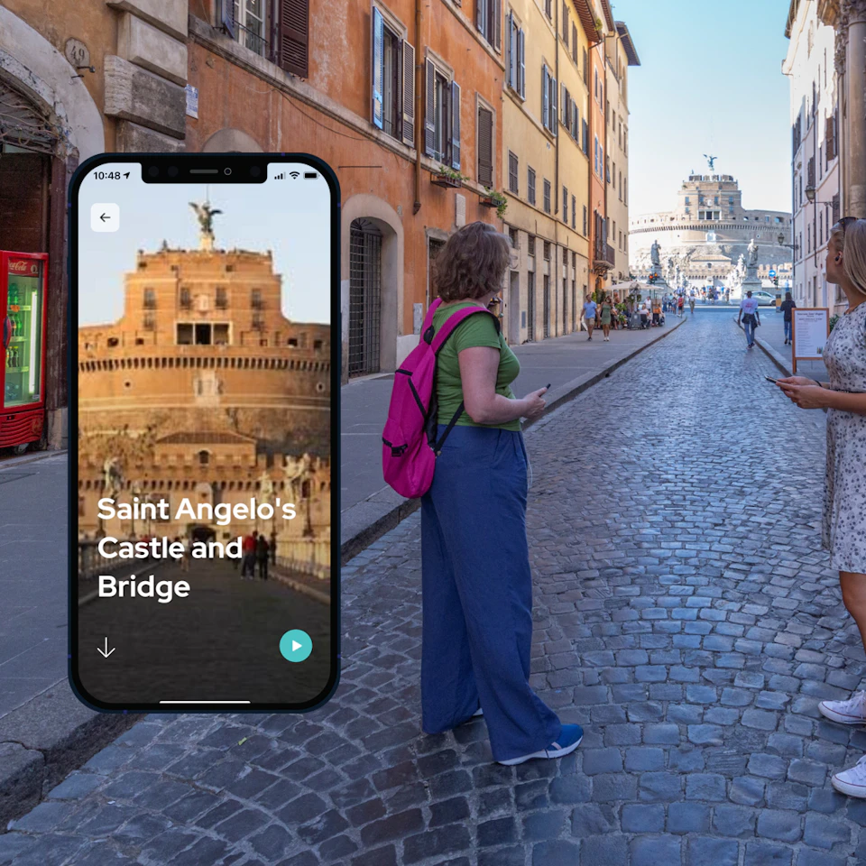 A woman with a pink backpack stands on a cobblestone street in front of a smartphone display showing "Saint Angelo's Castle and Bridge."