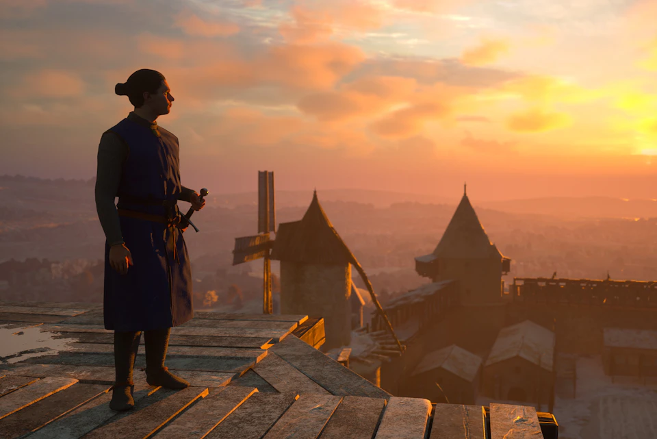 A person in medieval attire stands on wooden planks, overlooking a castle with conical roofs at sunset.