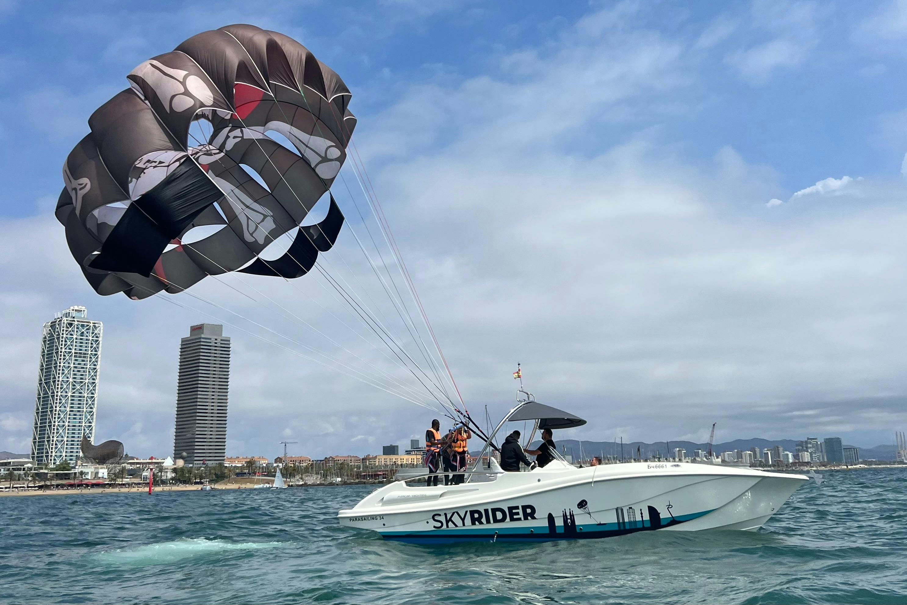 Parasailing with the background of Port Olimpic and Barcelona towers