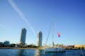 A sailboat sailing along the coast of Barcelona.