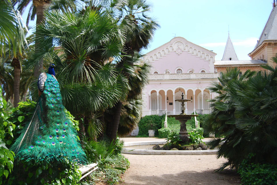 Colonial facade Palace Parc Sama Cambrils. Peacock