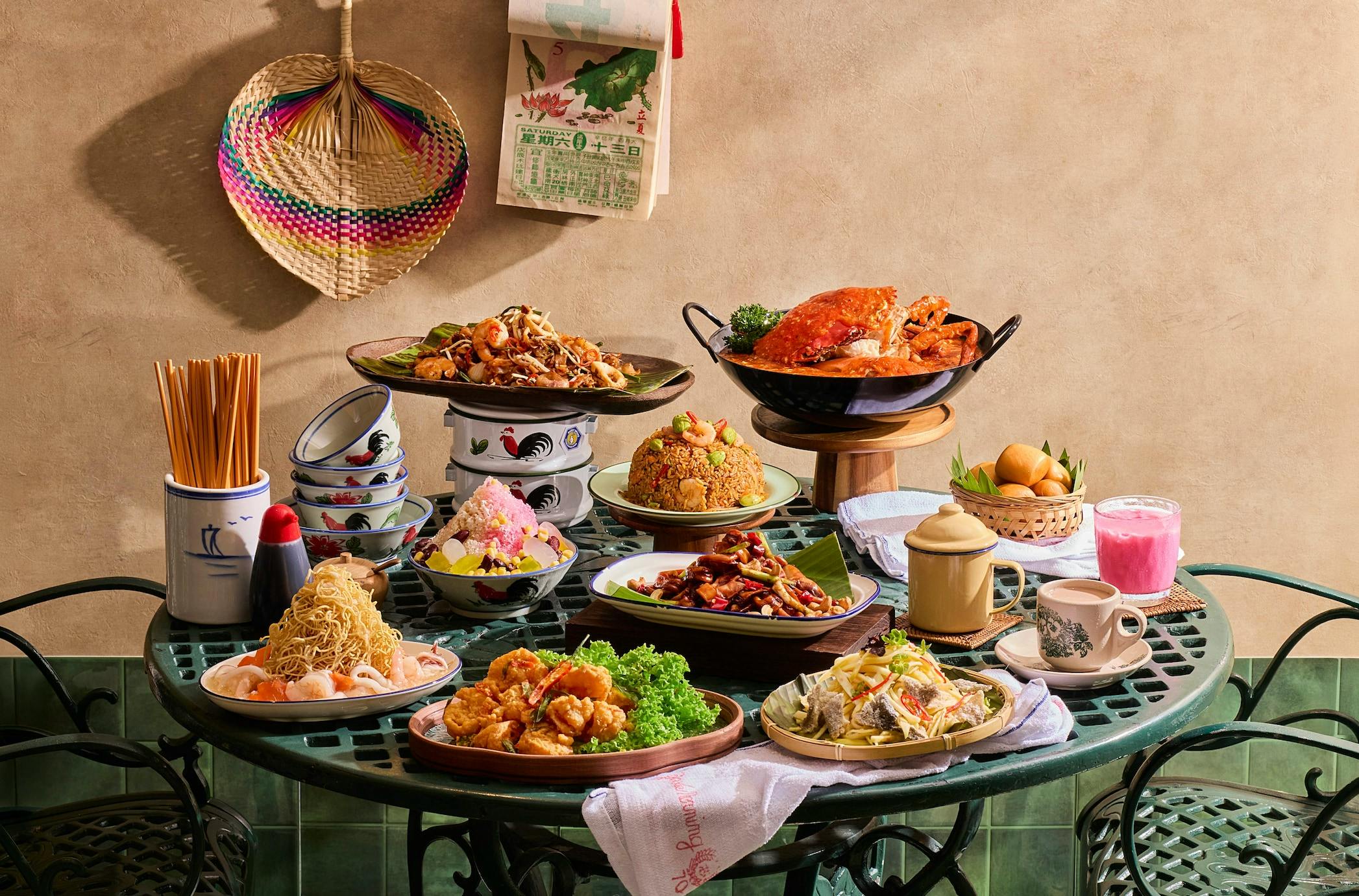 A table filled with various colorful dishes, including seafood, rice, and desserts, set in a cozy dining area.