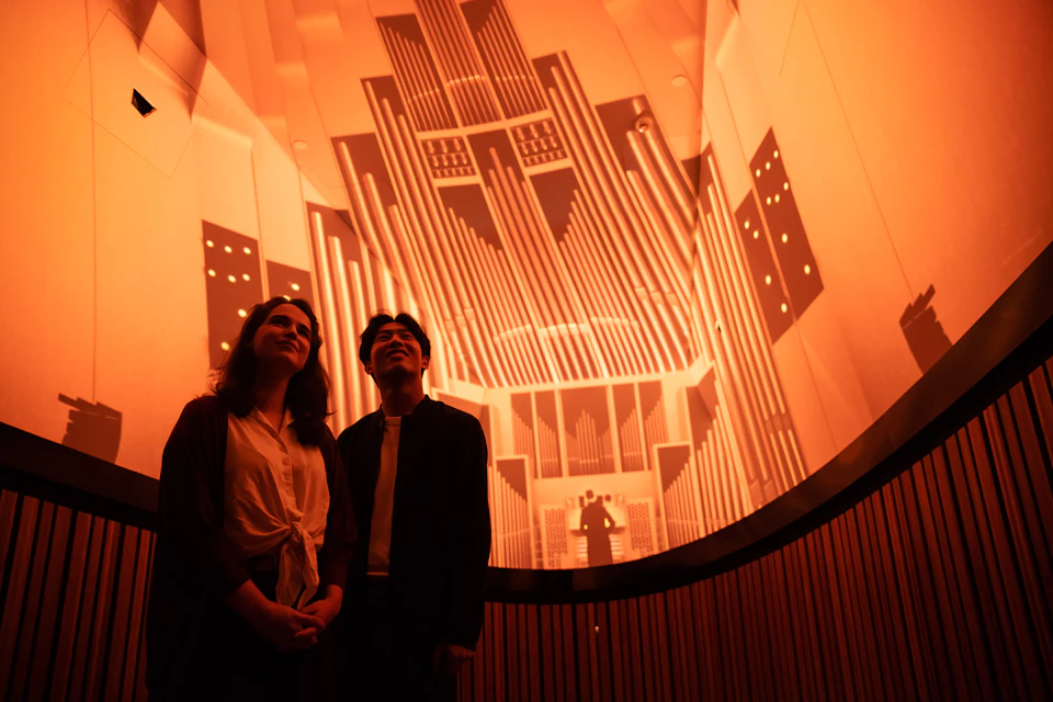 Visitors enjoying an immersive surround sound and visual experience.