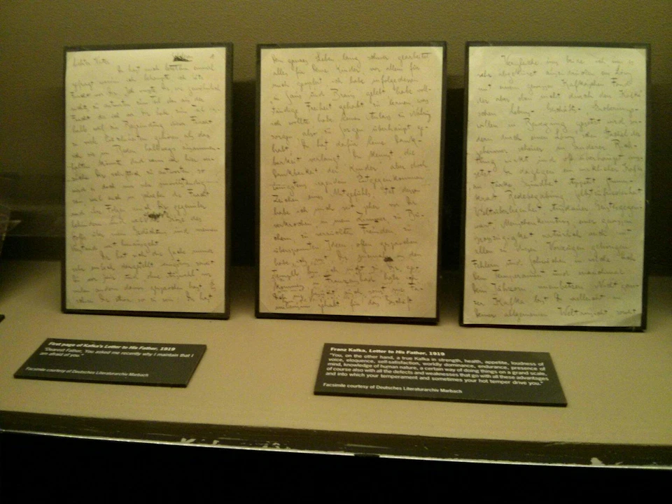 Three handwritten letters displayed in frames, accompanied by informational plaques below each letter.