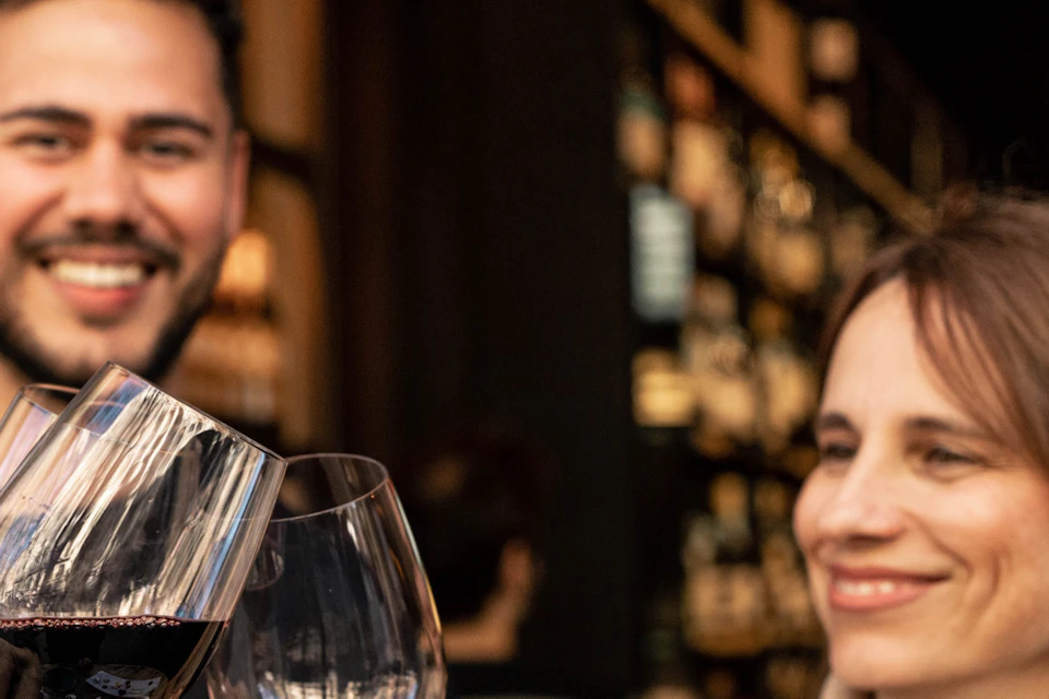 A group of friends enjoying a glass of red wine during a tour.