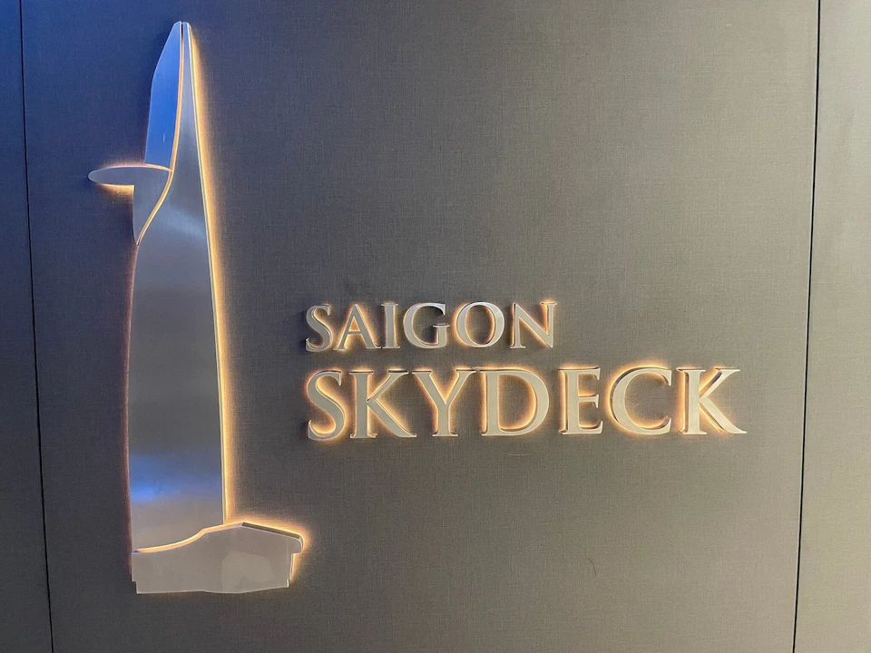 Sign with illuminated text reading 'Saigon Skydeck' and a stylized depiction of a building.