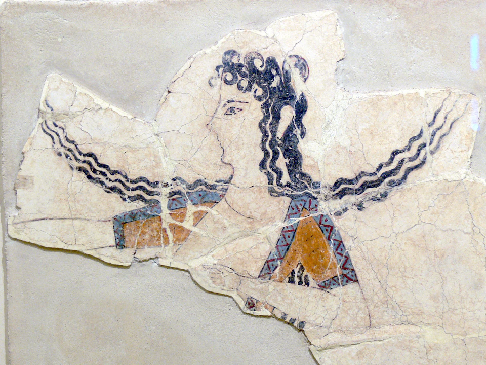 Ancient fresco fragment depicting a figure with curly hair, geometric-patterned garment, and intricate, colored designs.