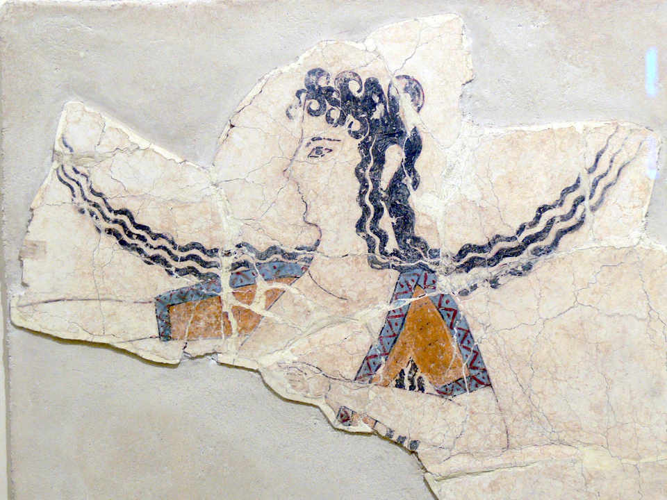 Ancient fresco fragment depicting a figure with curly hair, geometric-patterned garment, and intricate, colored designs.