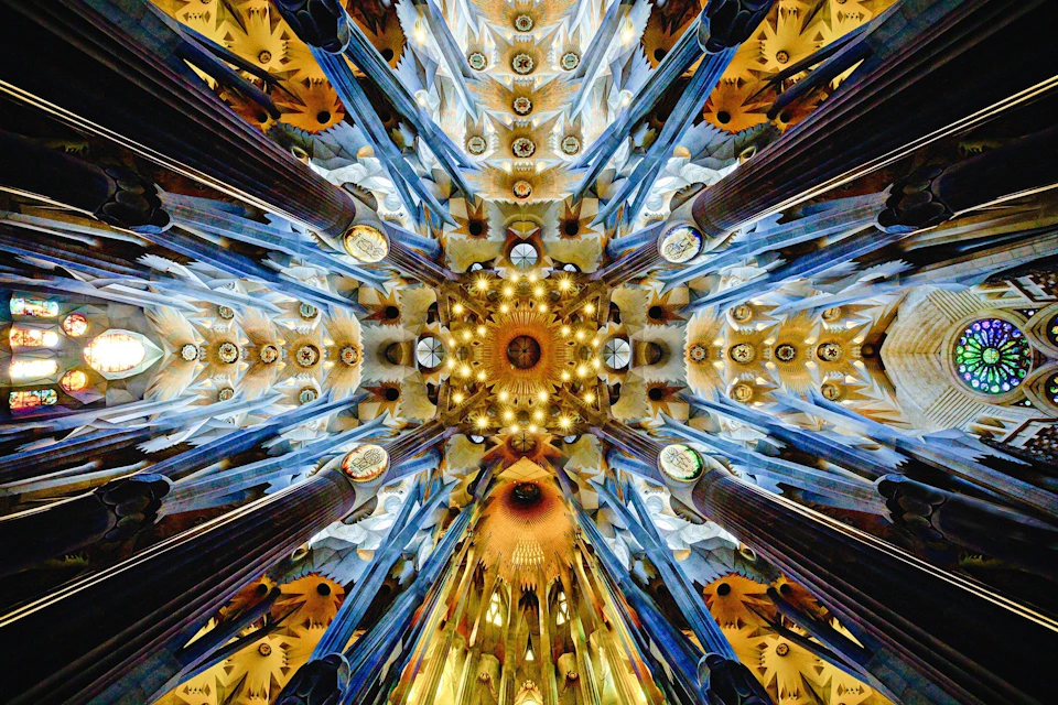 Intricate ceiling with colorful designs, stained glass, and columns, resembling a kaleidoscopic architectural pattern.
