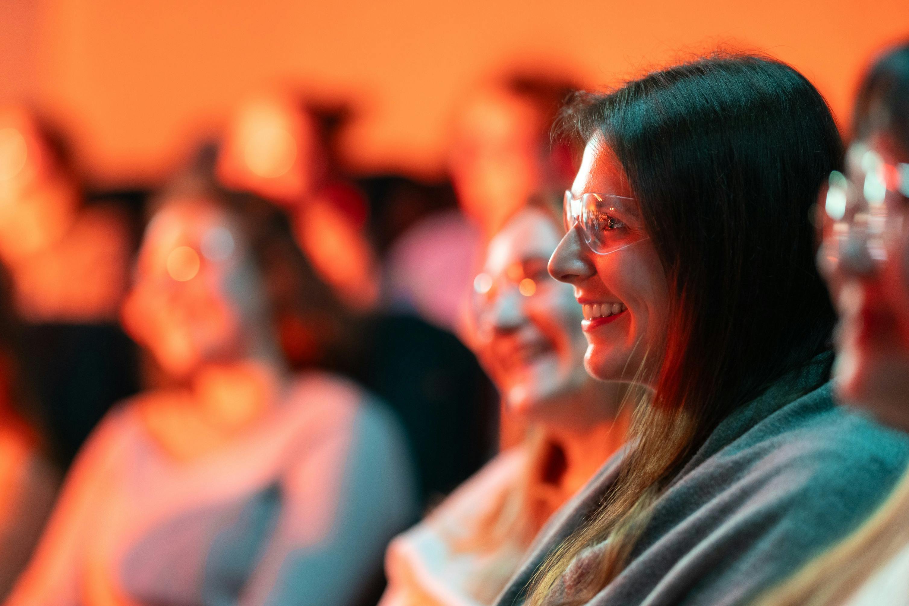 A woman with safety glass watches lava flow at the Lava Show in Iceland.