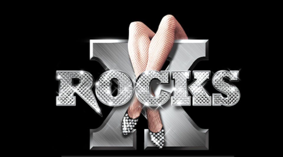 Sparkling "X ROCKS" text with crossed fishnet-clad legs and sparkling high heels against a black background.