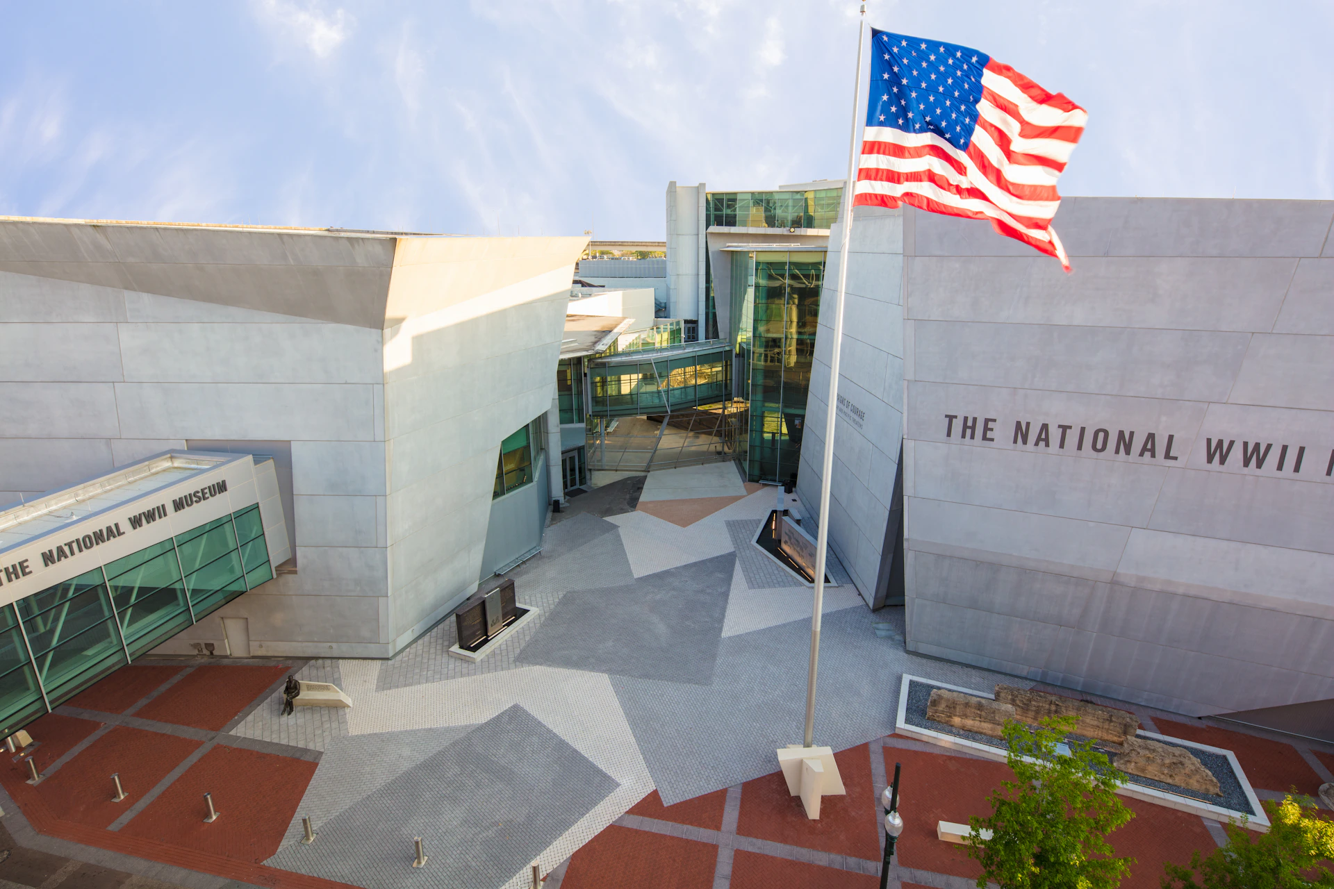 Modern building with geometric architecture and large American flag in front. Text "THE NATIO..." visible on the facade.