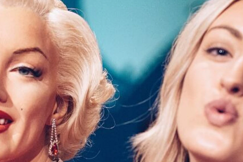 Tourist taking a self with wax figure of Marilyn Monroe at Madame Tussauds Hollywood