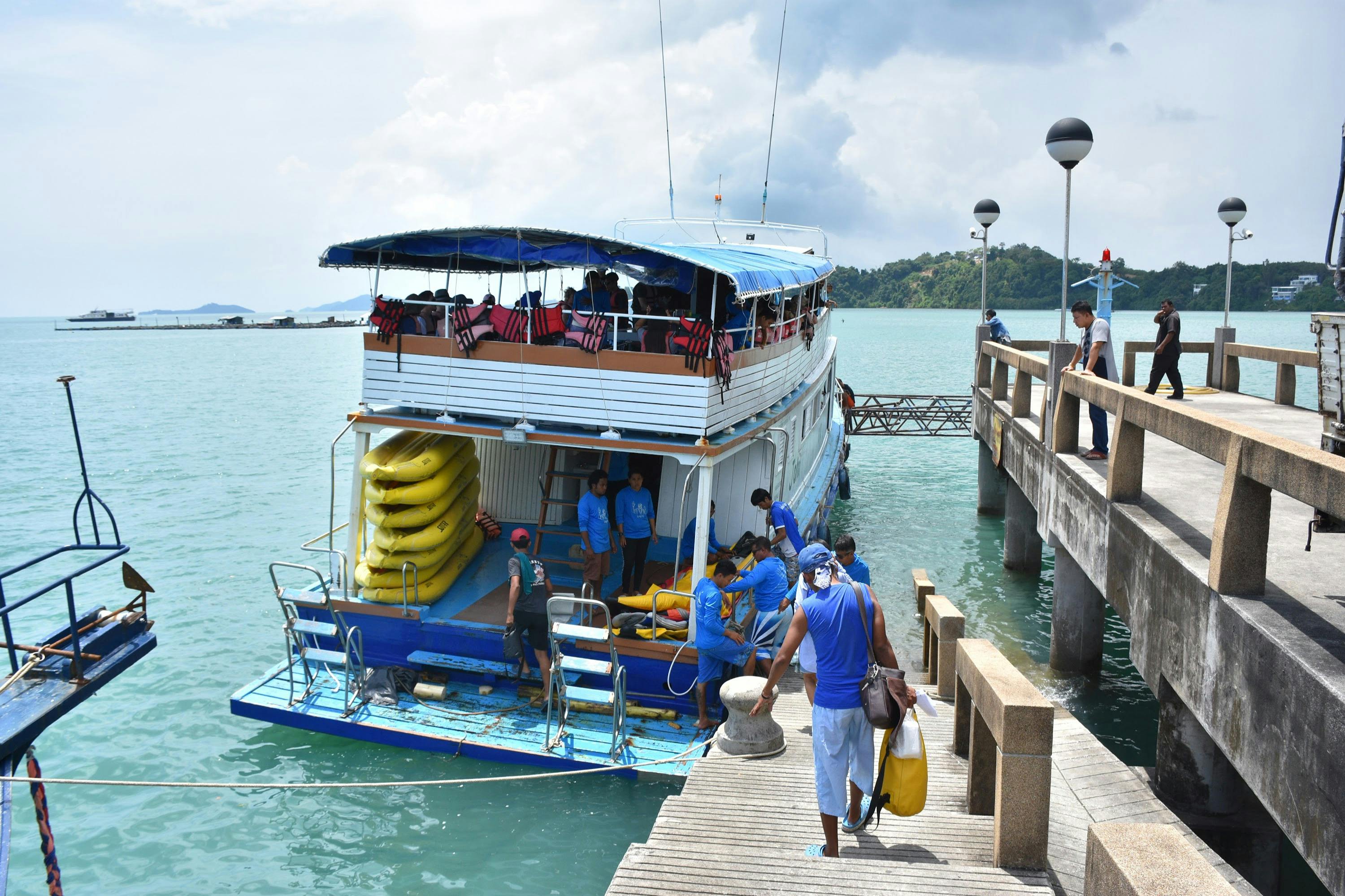 Board the escort boat at Ao Por Pier in Phuket