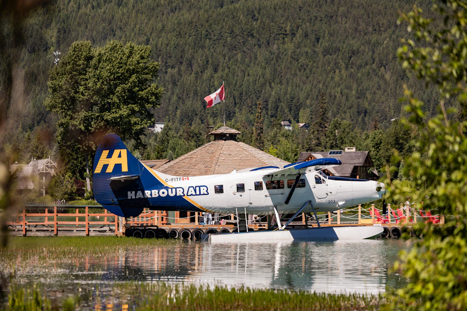 A seaplane with the terminal in the background.