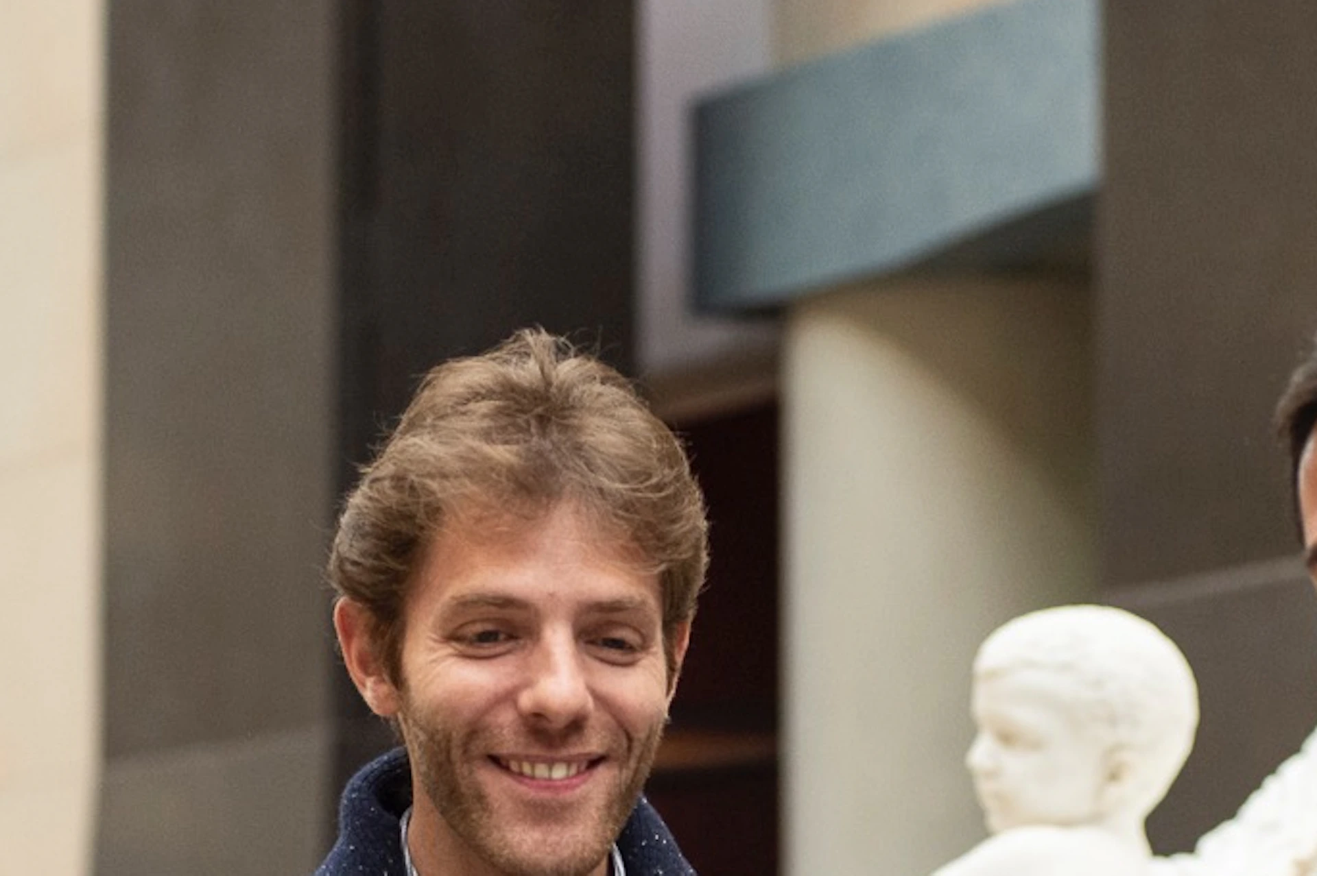 Tour guide leading a group through the museum