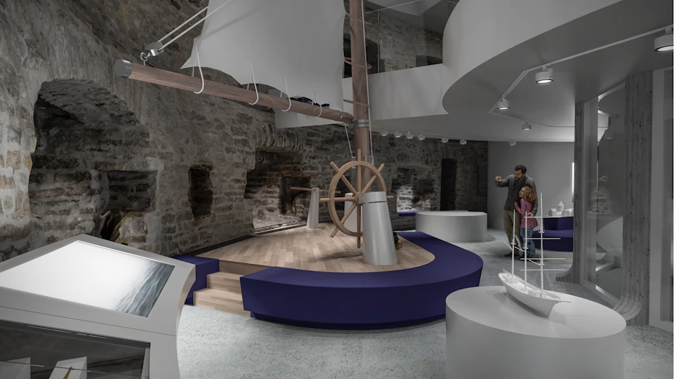 Museum exhibit with a ship's steering wheel, partial sail, and maritime displays. Visitors are observing and taking photos.