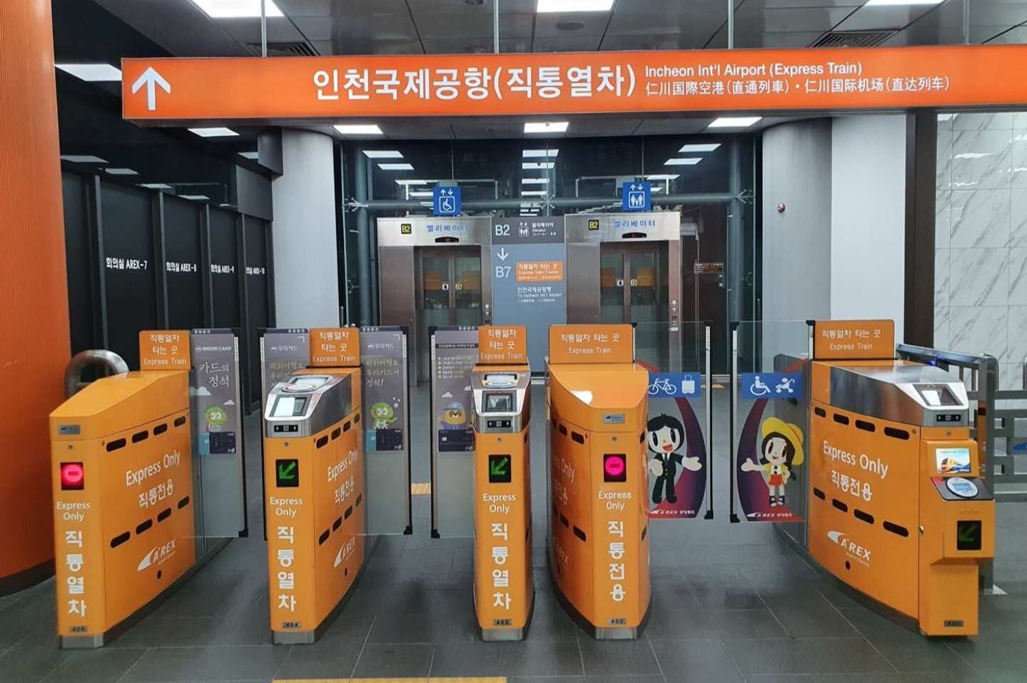 Automated ticket gates labeled "Express Only" at Incheon International Airport train station entrance, with elevator doors in the background.