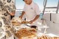yacht crew serving food to guests onboard
