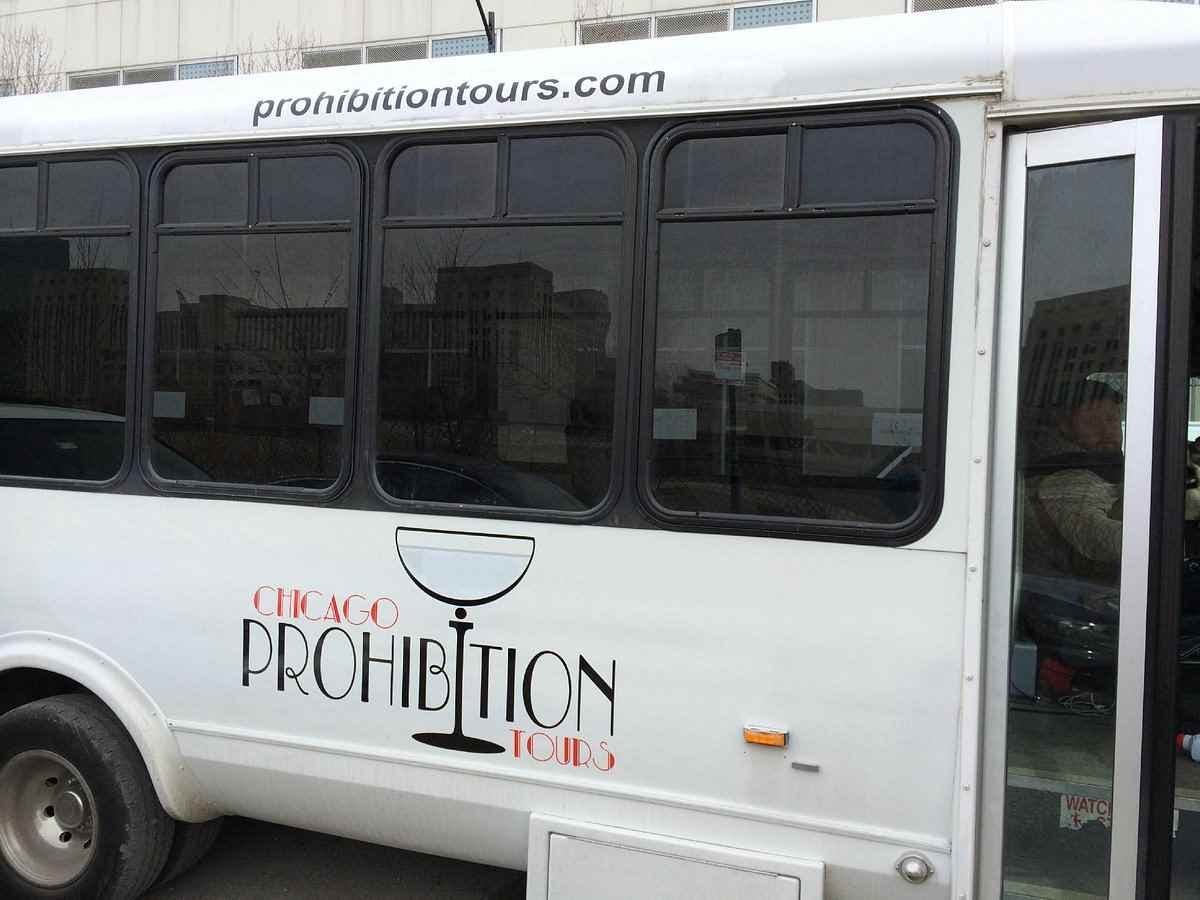 White bus with "Chicago Prohibition Tours" logo and website "prohibitiontours.com" on the side and above the windows.