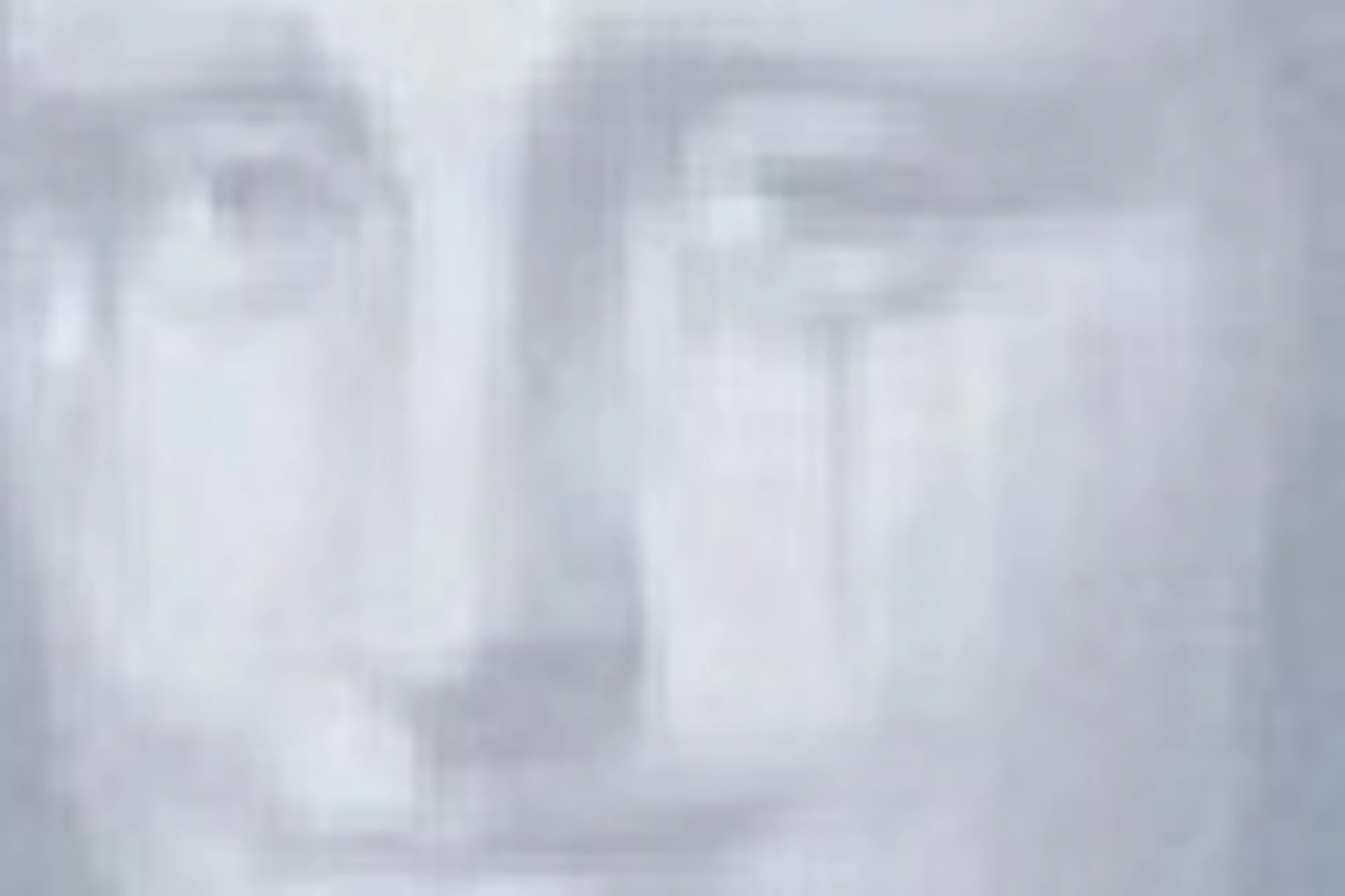 A person in a red dress standing in front of a grayscale artwork resembling the Mona Lisa in a gallery setting.