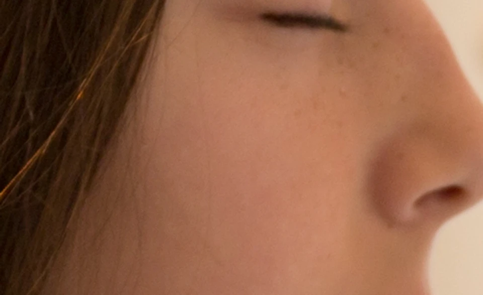 A girl tries to feel Braille.
