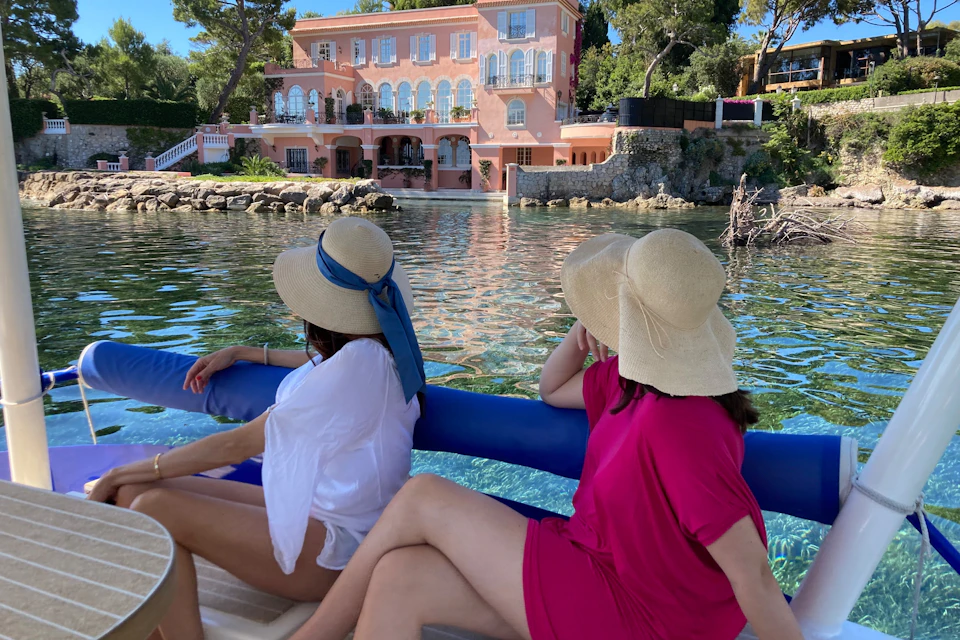 2 passengers admire a villa on the coast